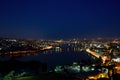 Night view of the Golden Horn sea bay, bridges, mosques, the historical center of Istanbul. The lights on in the houses.